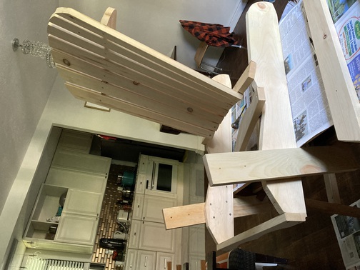 Nailing the back and base of a Muskoka chair.